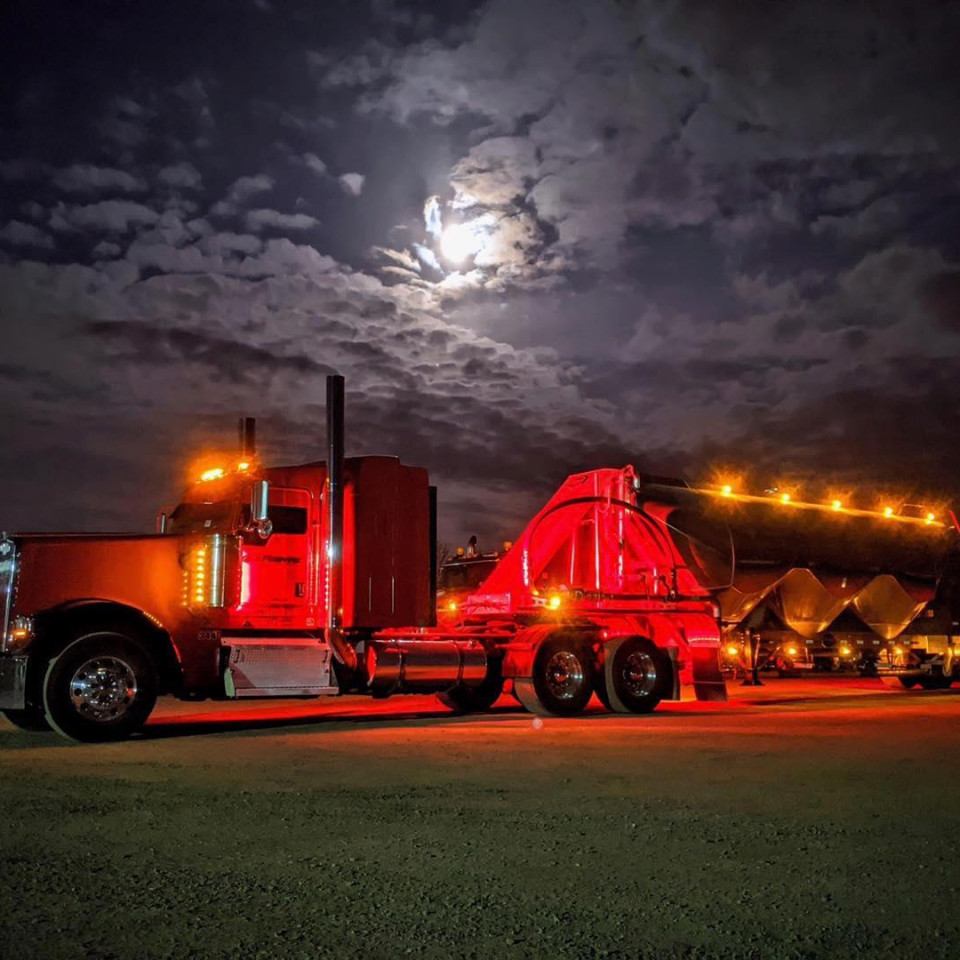 Lefbulk truck parked at LeFebvre Bulk Transport under a full moon at night.